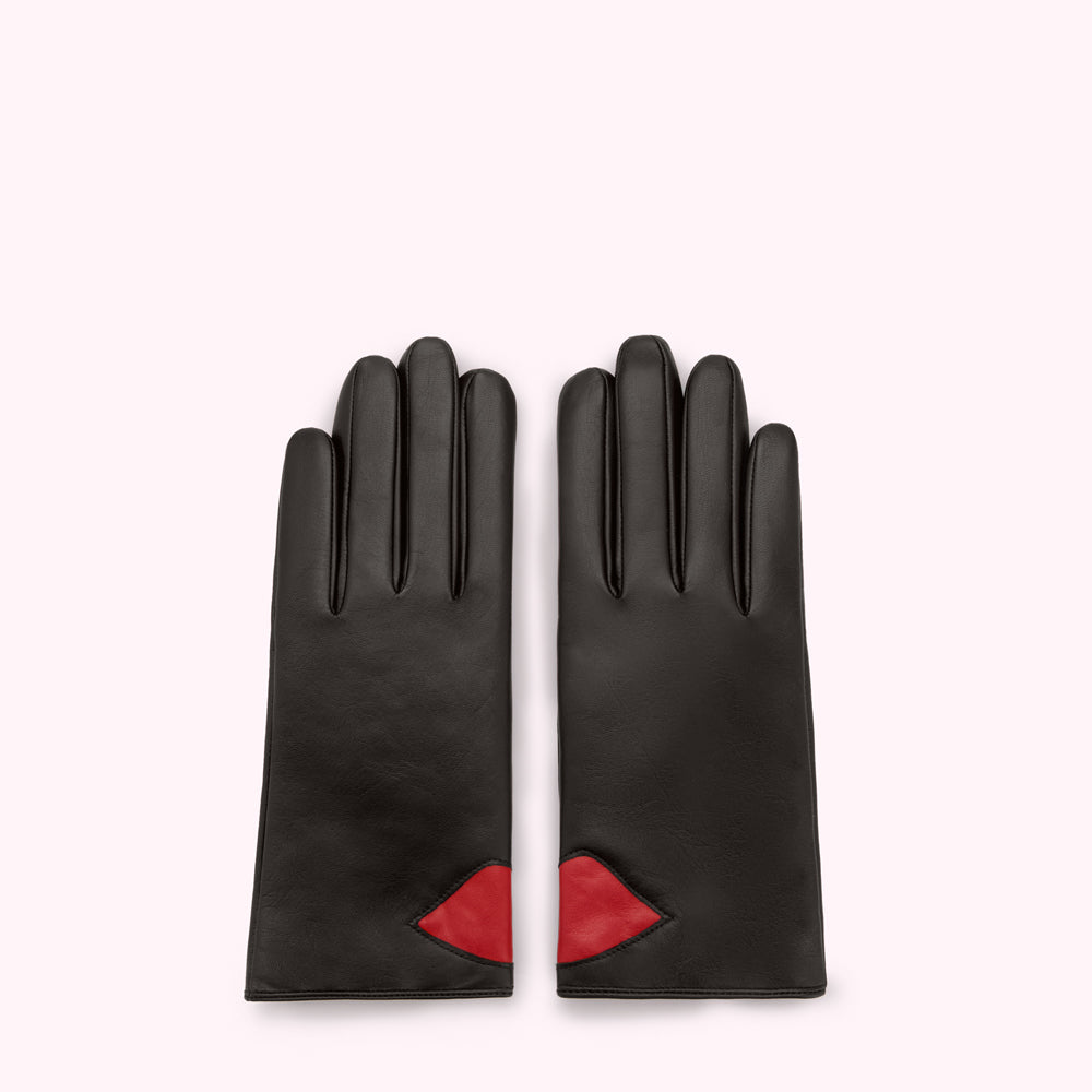 Pair of black leather gloves with red lip detail.
