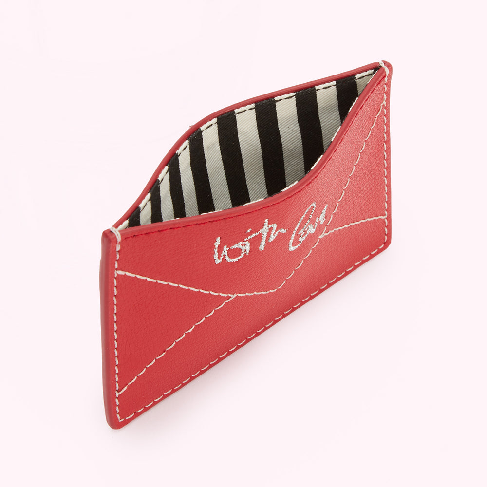 Red leather cardholder with a black and white striped interior and "With Love" written on the front.