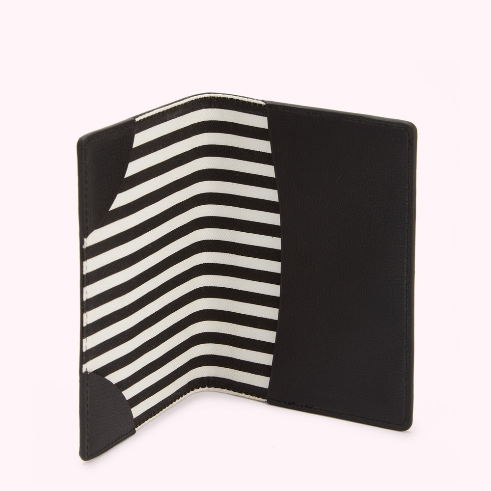 Black passport holder open to reveal a black and white striped interior.
