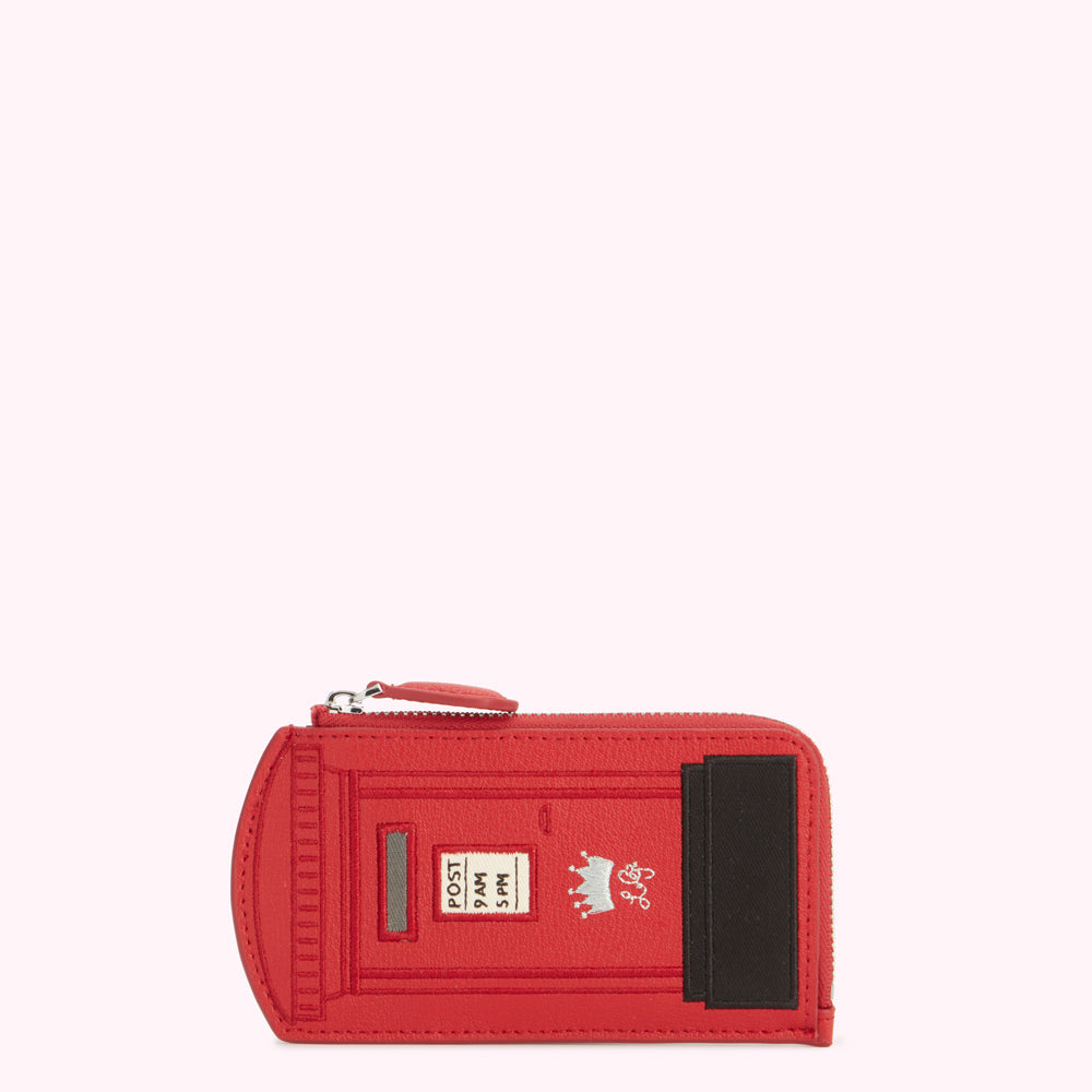 Red leather coin purse shaped like a British post box.
