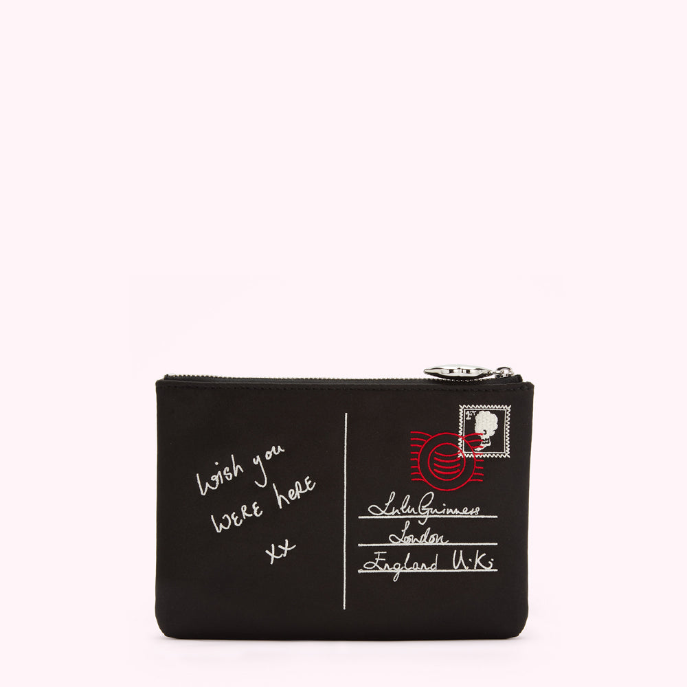 Black zip pouch with a postcard design featuring the text "Wish you were here xx" and "Lulu Guinness London England U.K." embroidered on it.