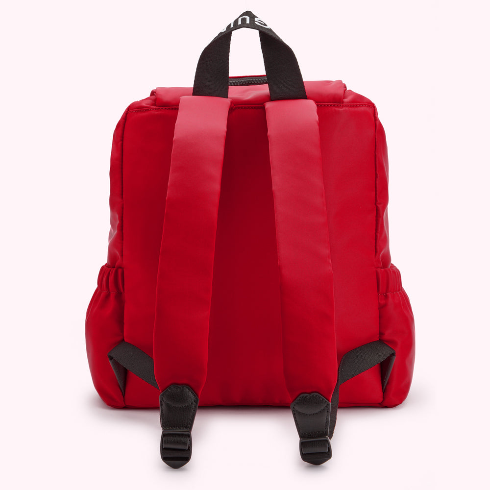 Red backpack with black carrying handle and white logo.