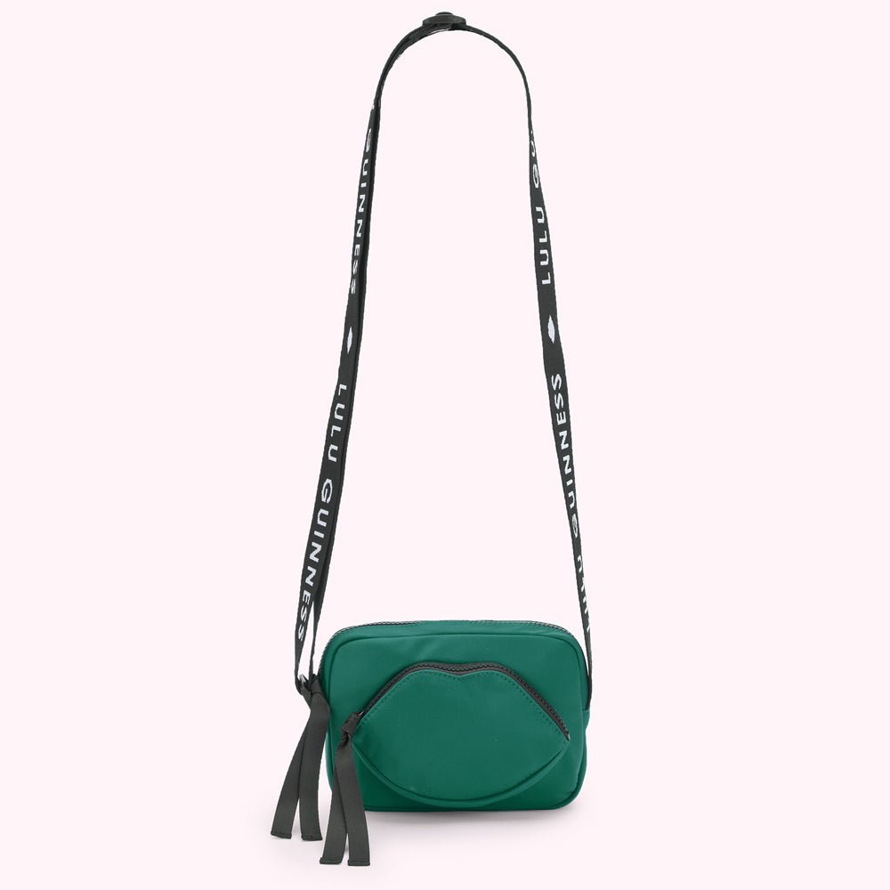 Green Lulu Guinness crossbody bag with black strap.