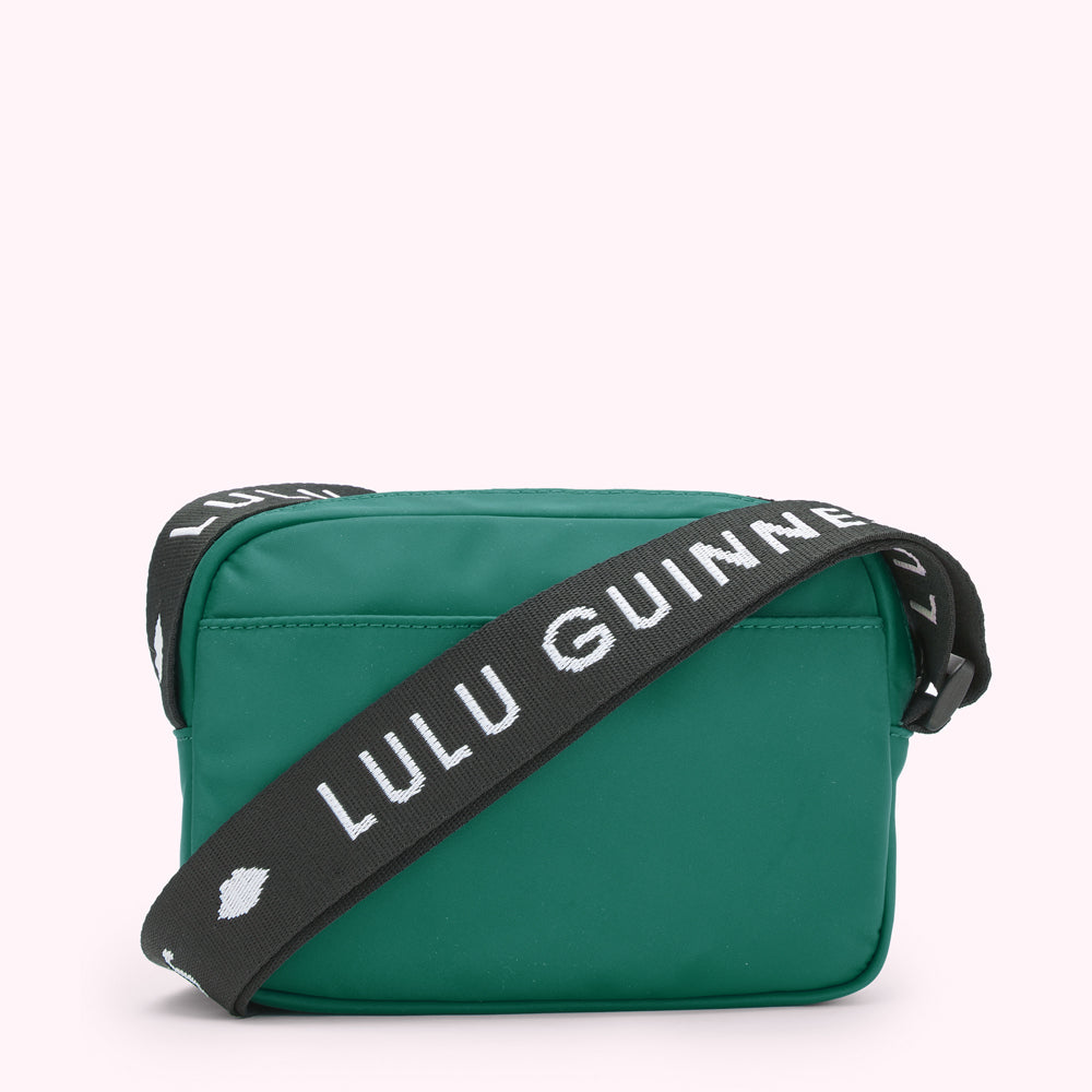 Green Lulu Guinness crossbody bag with black and white strap.