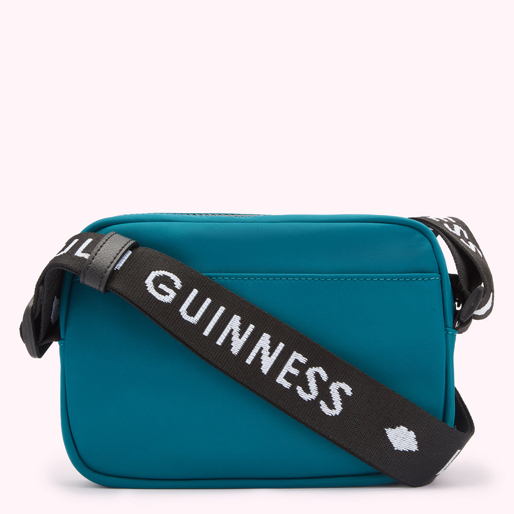 Teal Lulu Guinness crossbody bag with black and white strap.