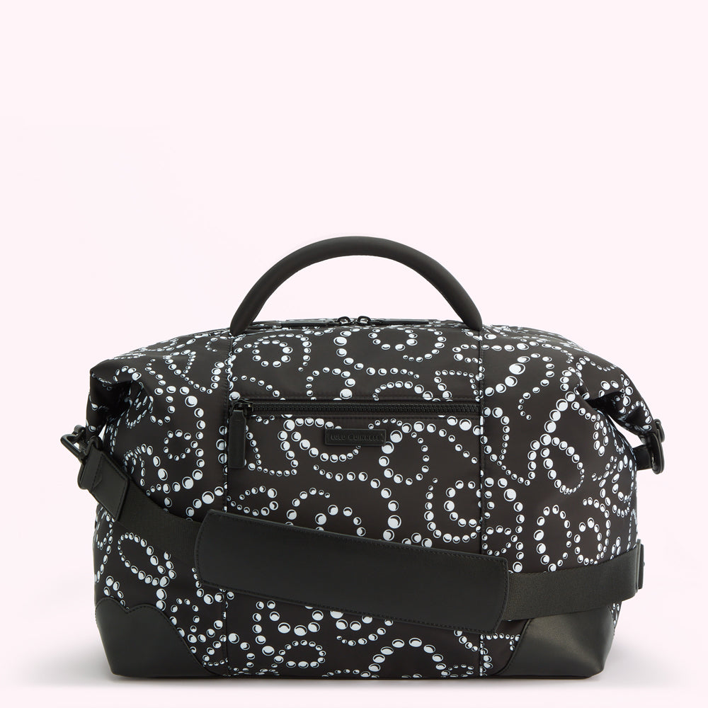 Black duffel bag with white pearl pattern.