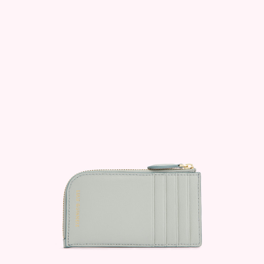 Light blue leather cardholder with gold zipper and logo.
