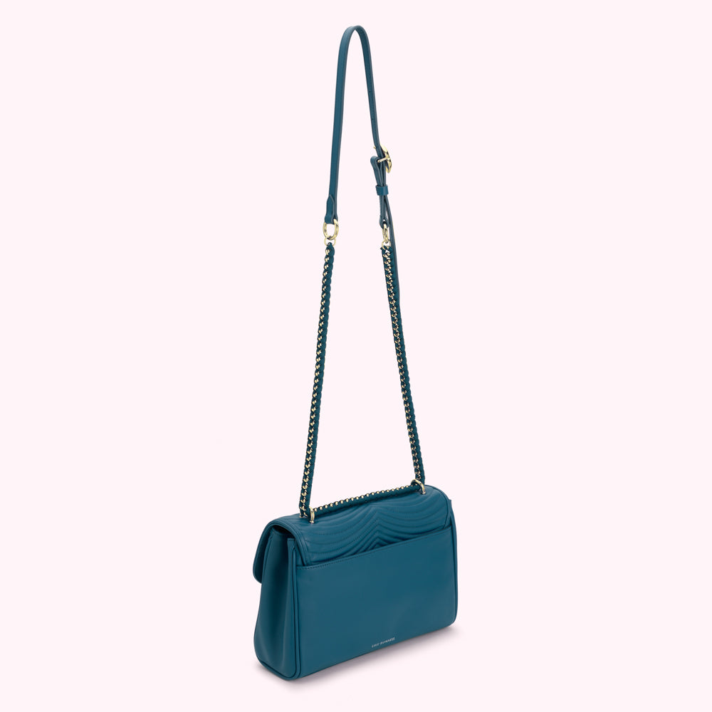 Teal quilted shoulder bag with gold chain strap.
