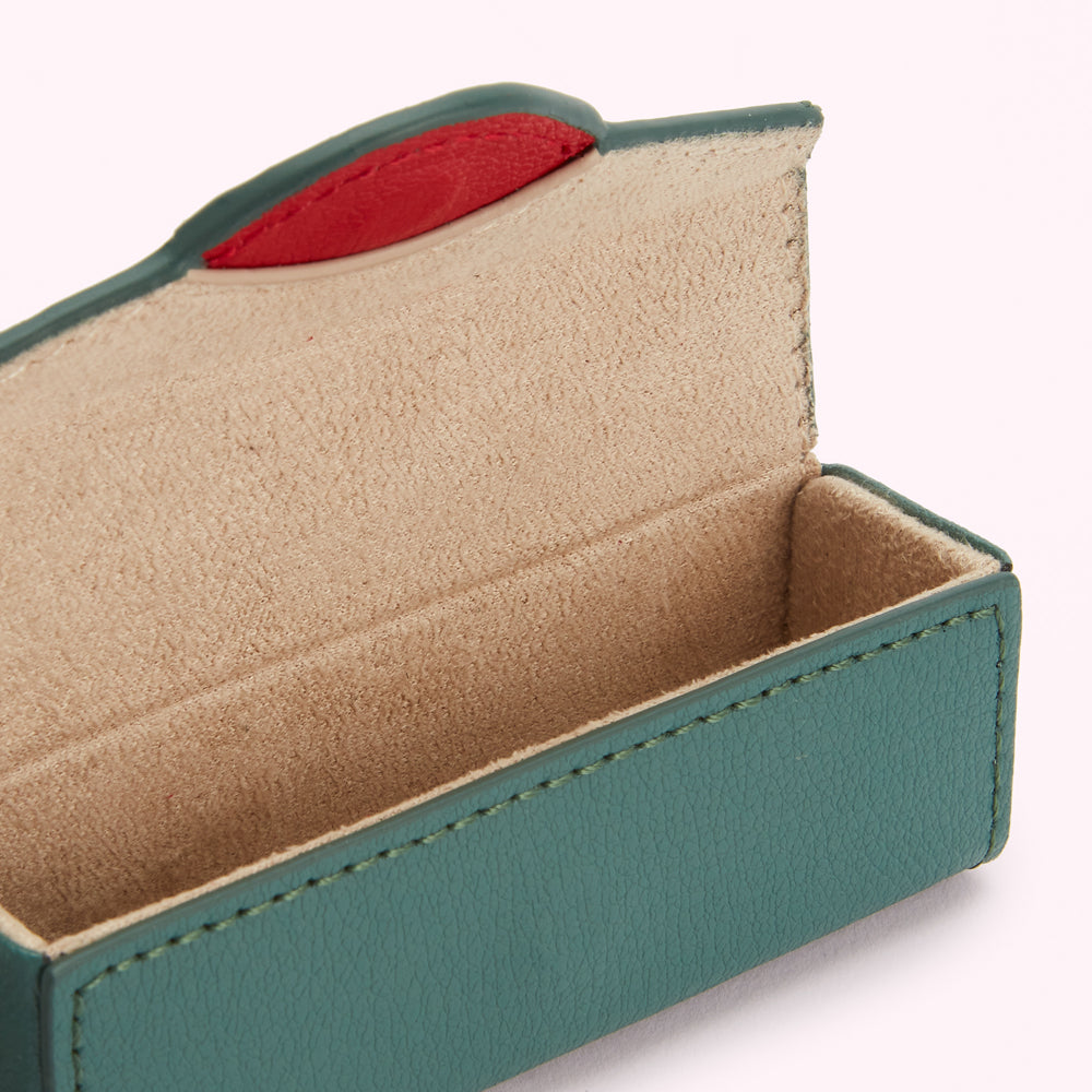 Dark teal leather eyeglasses case open to reveal a beige suede interior.