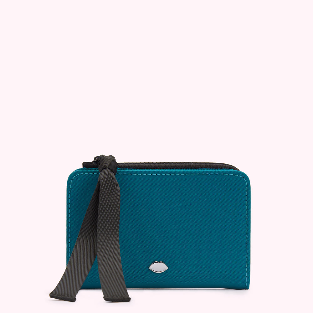 Teal zippered wallet with black ribbon detail and silver lip logo.
