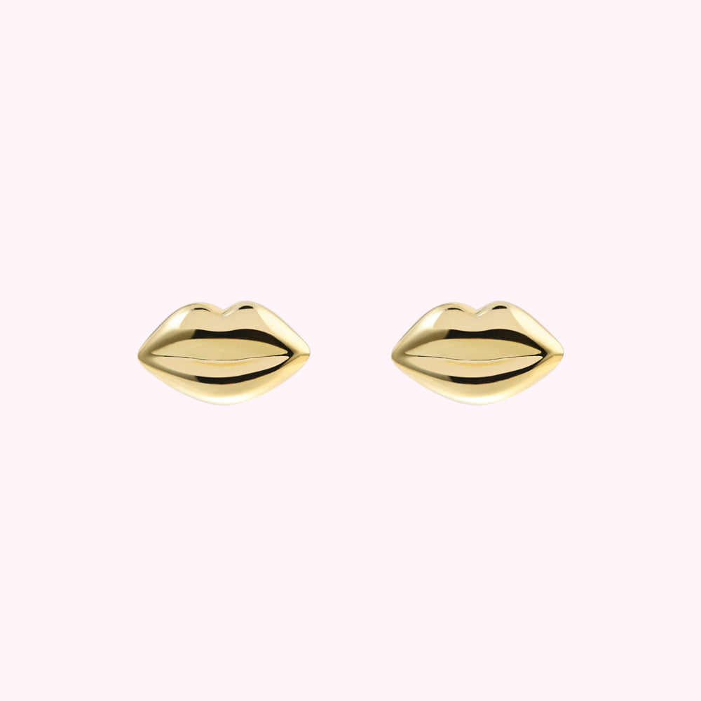 Pair of gold lip-shaped stud earrings against a white background.
