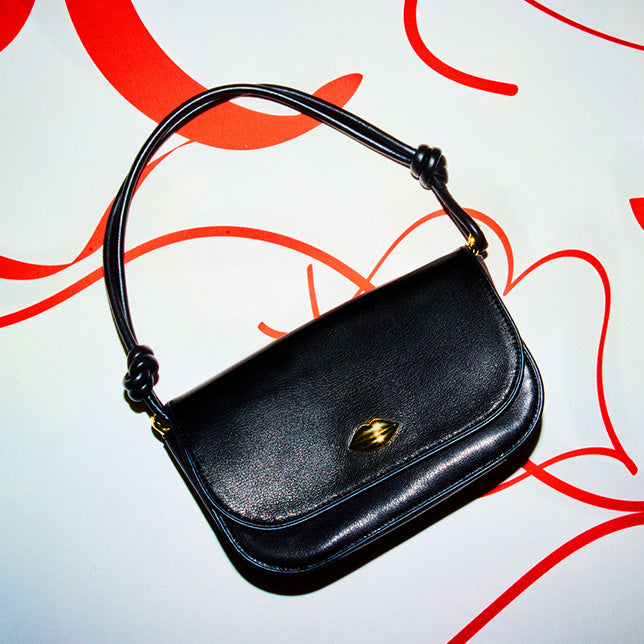Lot - Five Lulu Guinness bags to include a boxed evening bag with shop  front design, a quilted black patent handbag,