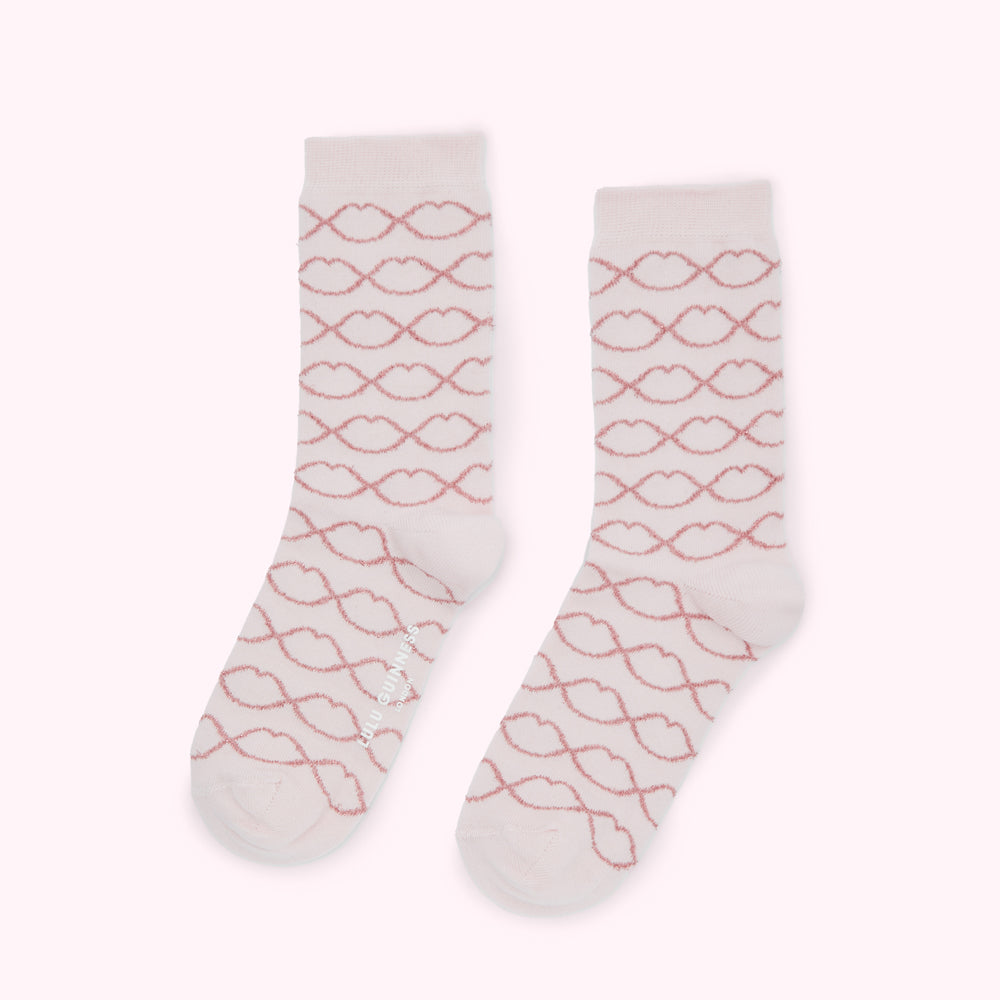 Pair of pink socks with a rose gold lip pattern.
