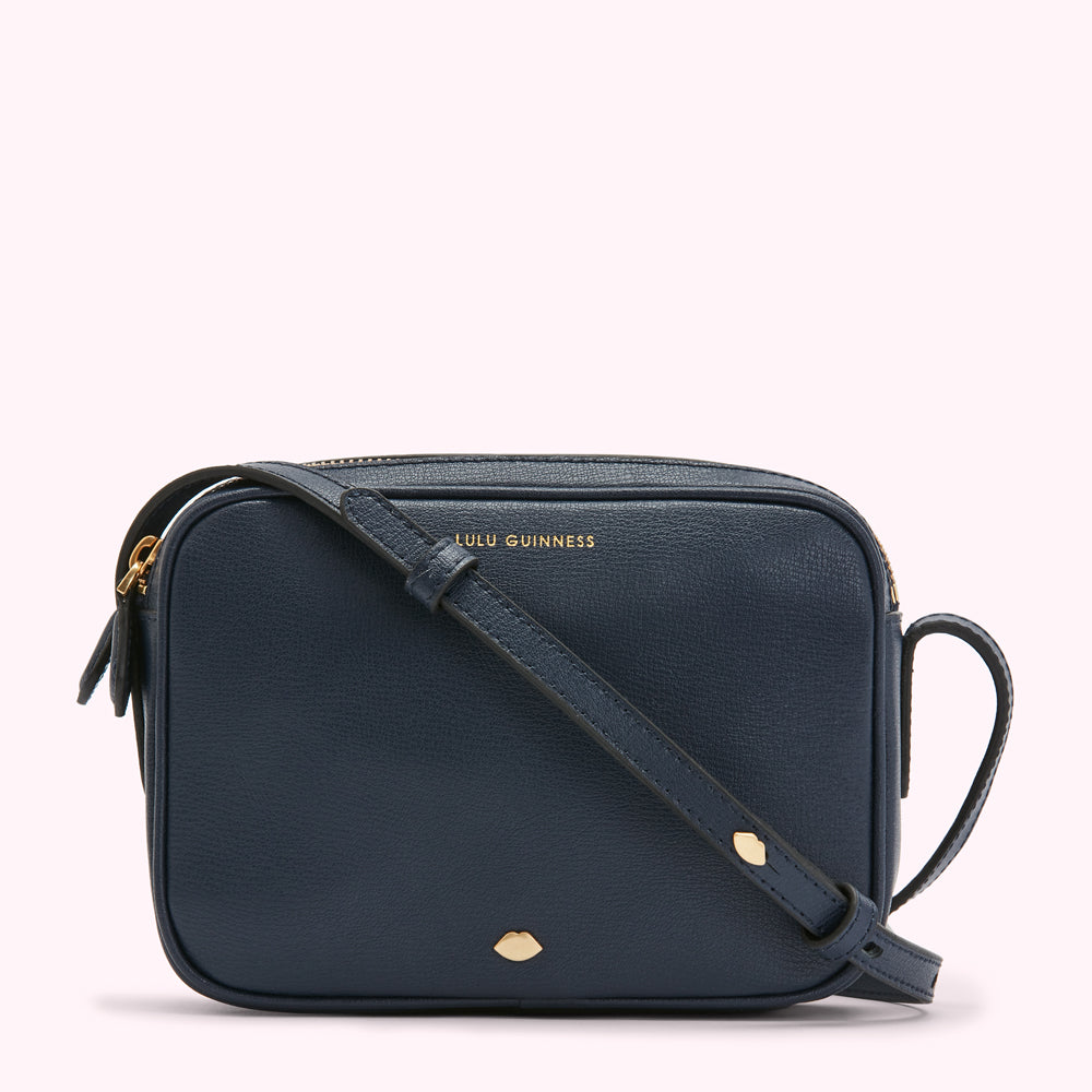 Navy blue Lulu Guinness crossbody bag with gold hardware.
