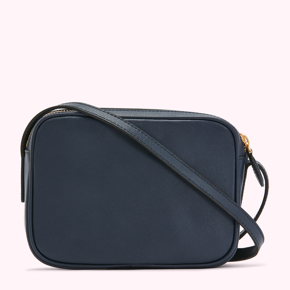 Navy blue rectangular crossbody bag with a gold zipper.
