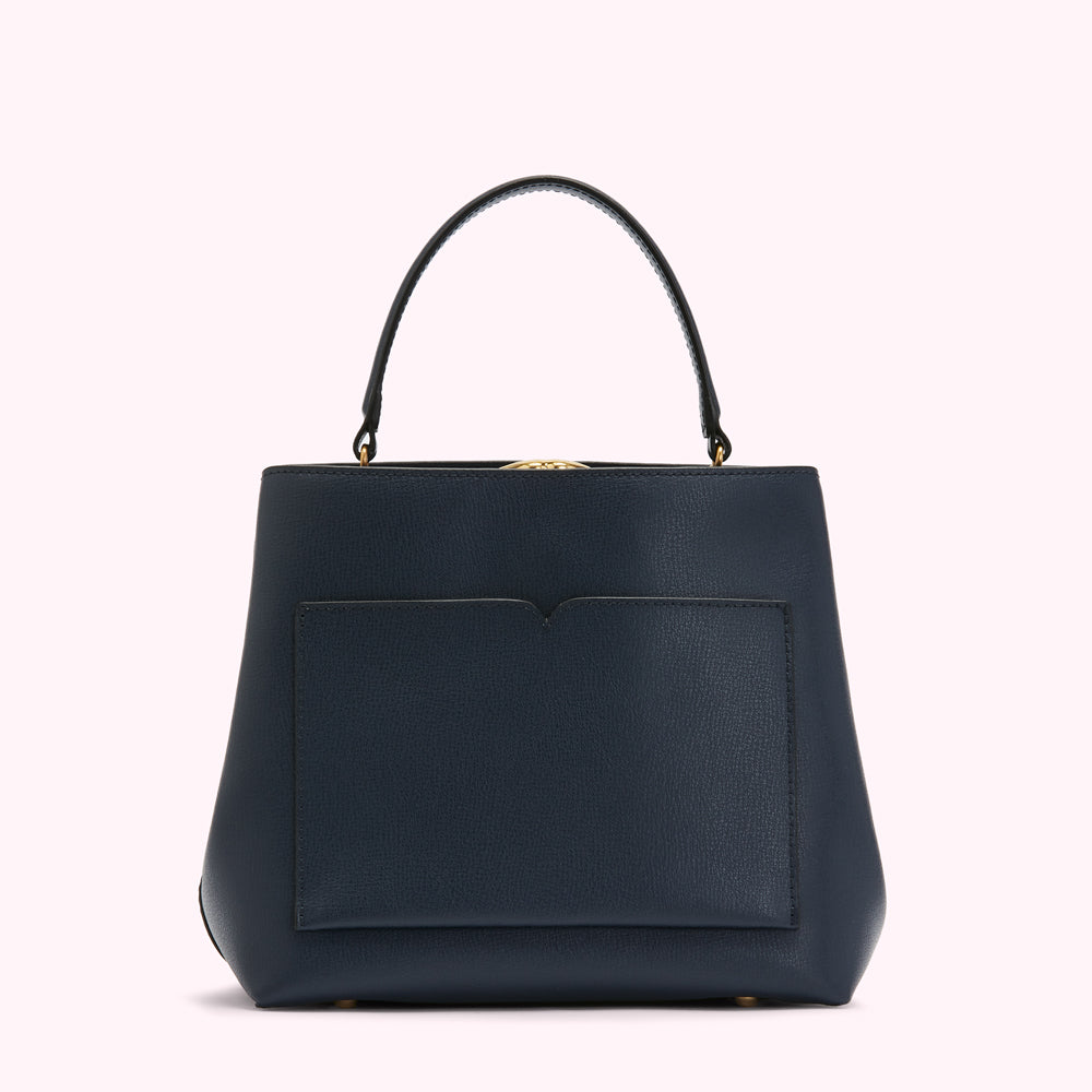 Dark blue leather handbag with a top handle and a front pocket against a white background.
