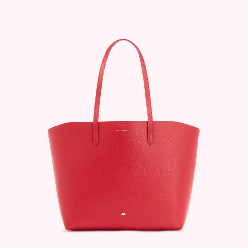 Red Lulu Guinness tote bag on white background.
