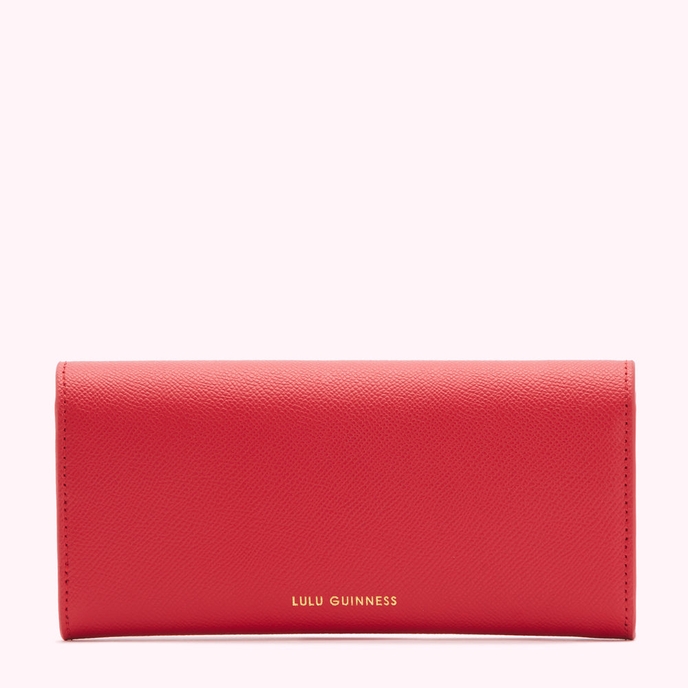 Red Lulu Guinness wallet against a white background.
